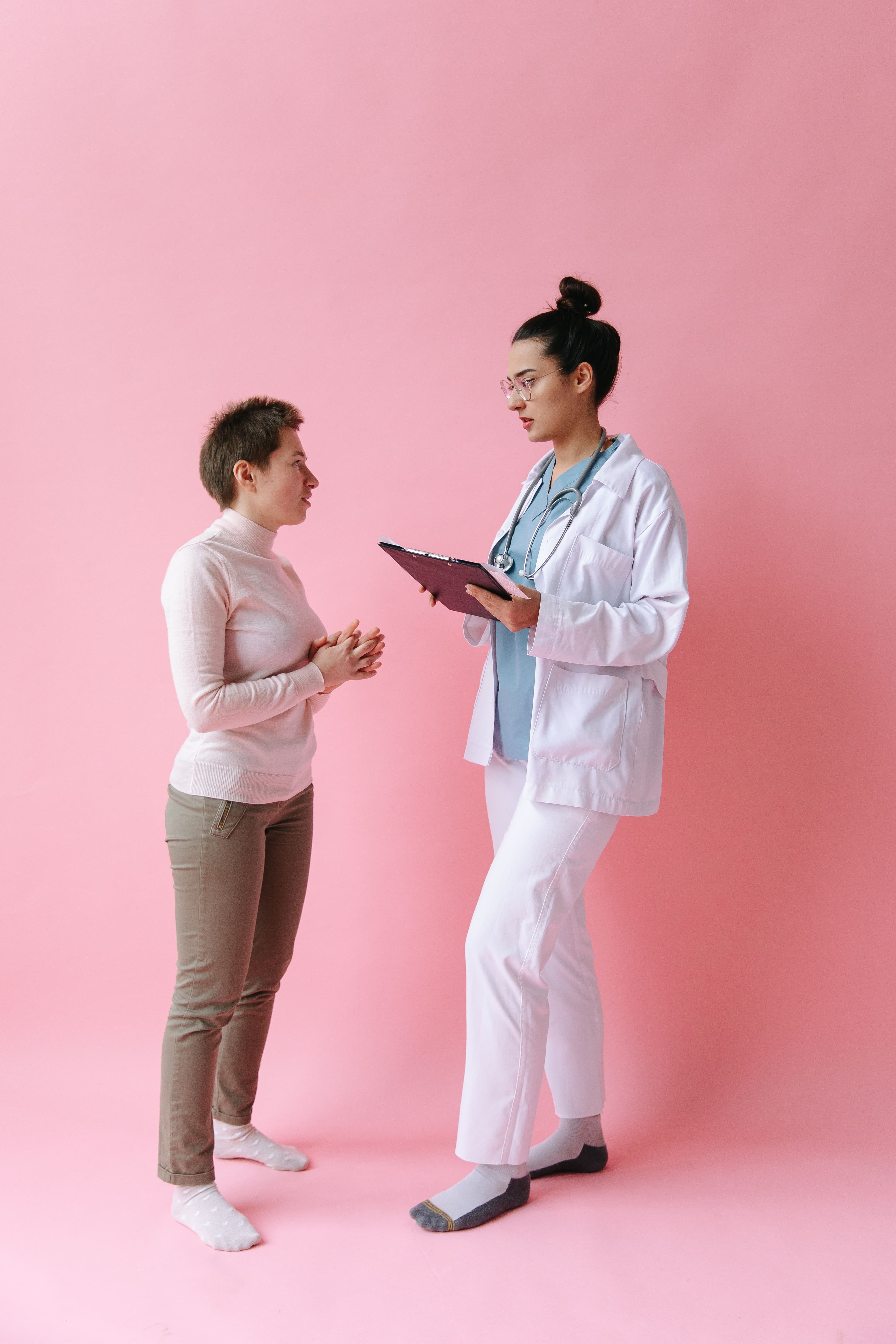 An NYC Health + Hospital / District doctor consulting with a patient
